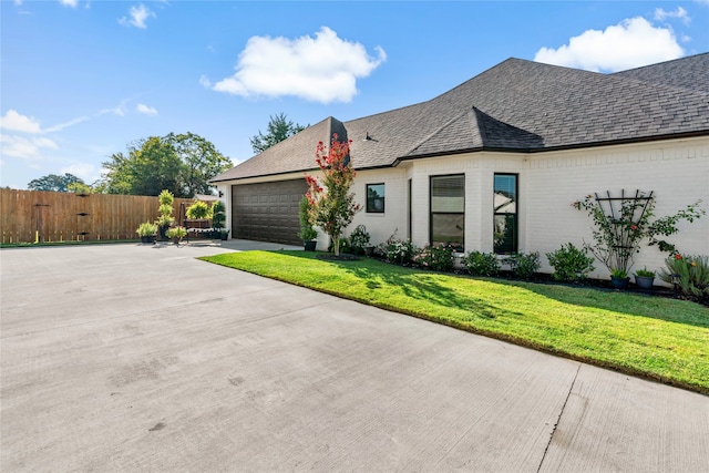 view of property exterior with a lawn and a garage