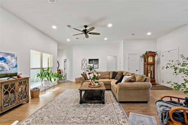 living room with light hardwood / wood-style floors and ceiling fan