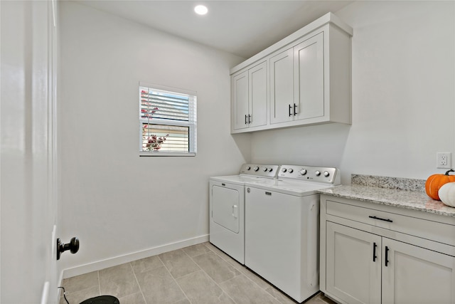 laundry area with independent washer and dryer and cabinets