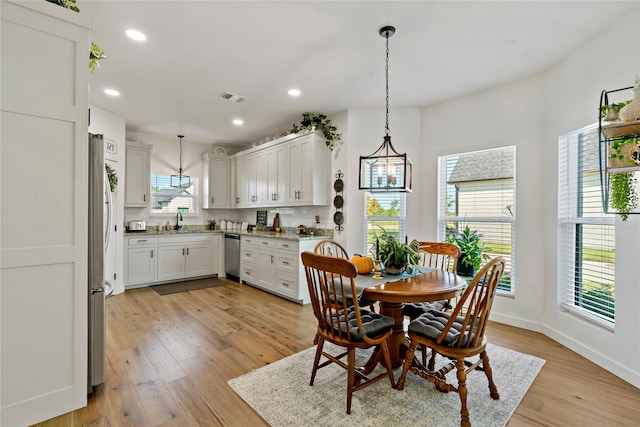 dining room featuring light wood-type flooring and sink