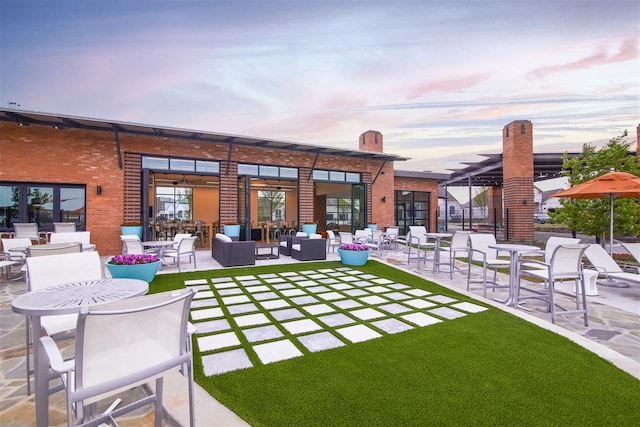 yard at dusk with an outdoor hangout area and a patio area