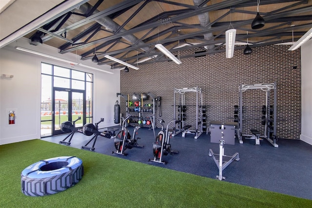 workout area with high vaulted ceiling