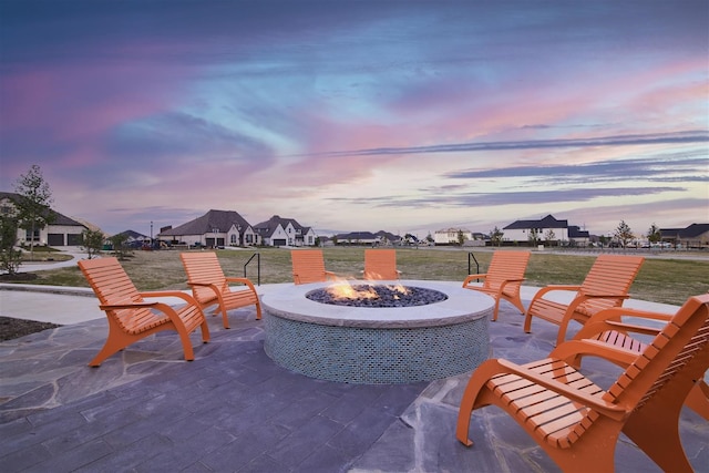 patio terrace at dusk featuring a fire pit