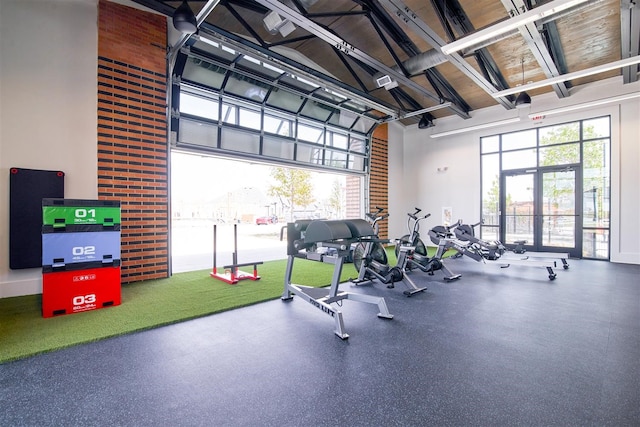 gym with a towering ceiling