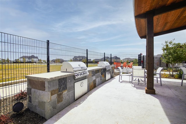 view of patio / terrace with area for grilling and a grill