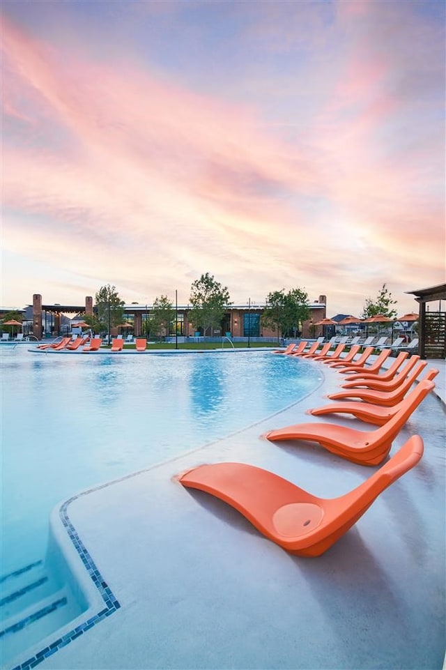 view of pool at dusk