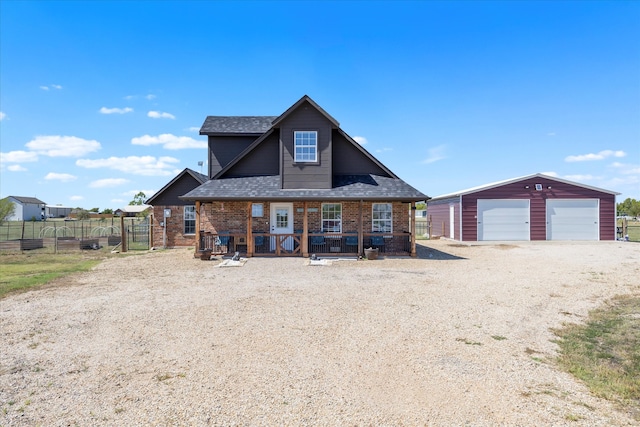 view of front of home with an outbuilding, covered porch, and a garage