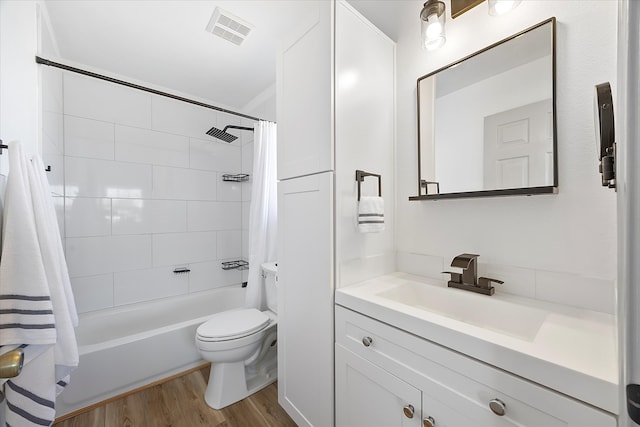 full bathroom with vanity, toilet, shower / bathtub combination with curtain, and hardwood / wood-style floors