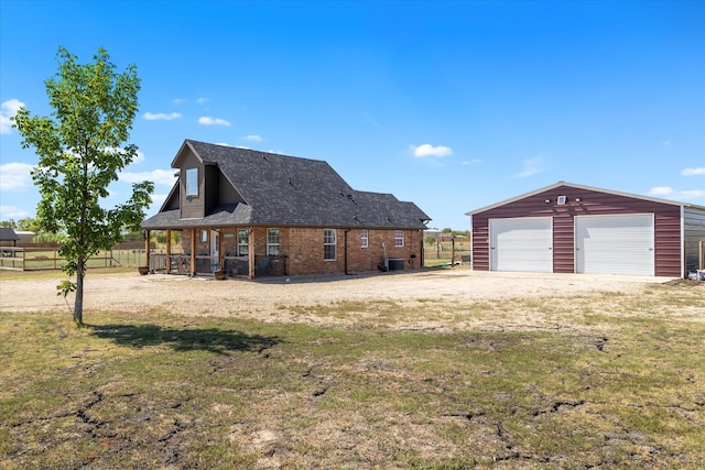 view of side of home featuring central AC, an outbuilding, a garage, and a lawn