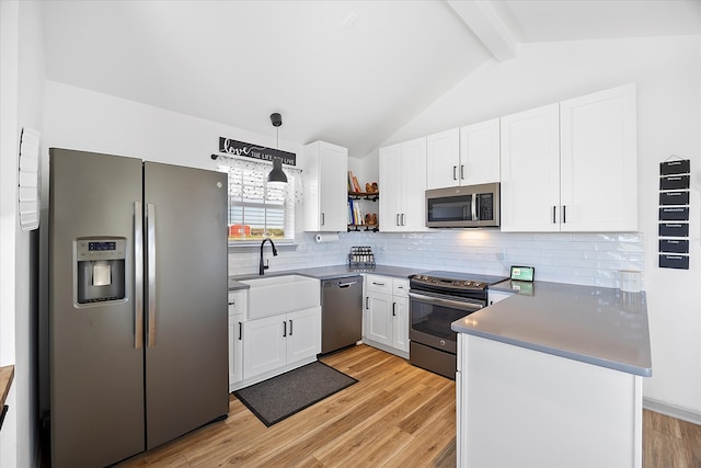 kitchen with light hardwood / wood-style floors, stainless steel appliances, decorative light fixtures, and white cabinets