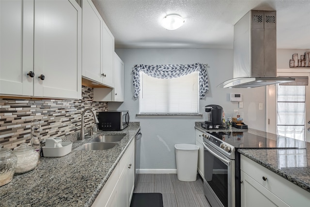 kitchen featuring white cabinets, sink, stone countertops, island range hood, and stainless steel appliances