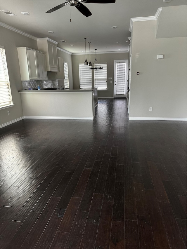 unfurnished living room with ceiling fan, dark wood-type flooring, and crown molding