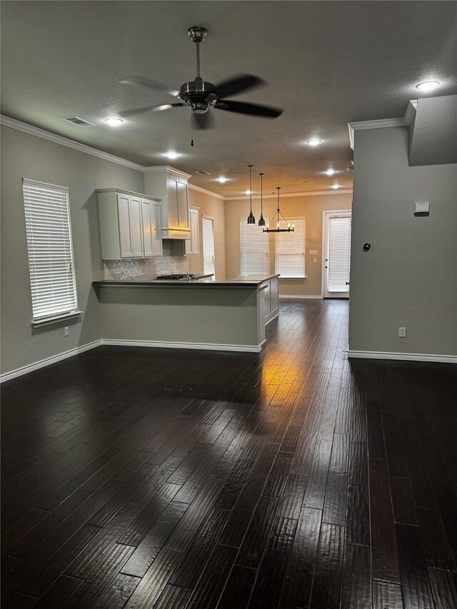 514 Sheer Bliss Ln, Fort Worth, TX 76114 - kitchen featuring a ceiling fan, dark wood-style floors, a peninsula, ornamental molding, and pendant lighting