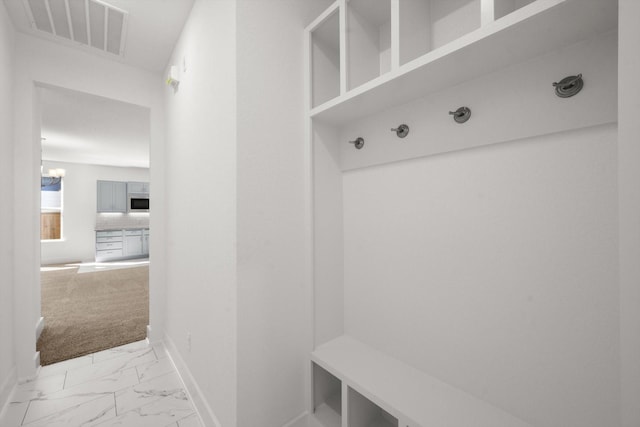 mudroom with light colored carpet