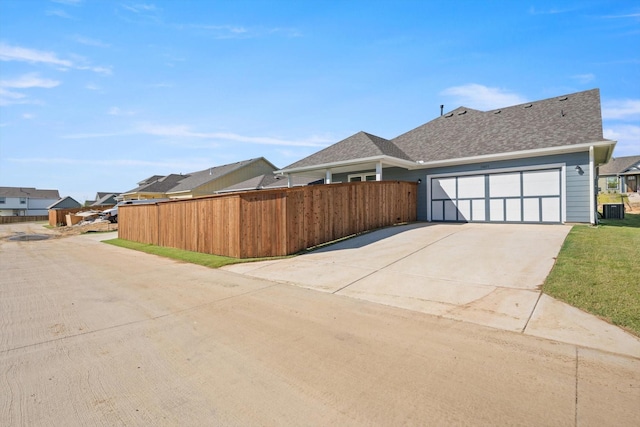 view of property exterior featuring a garage and central AC