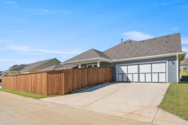 view of property exterior featuring central AC and a garage