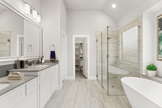 bathroom with plus walk in shower, high vaulted ceiling, and vanity