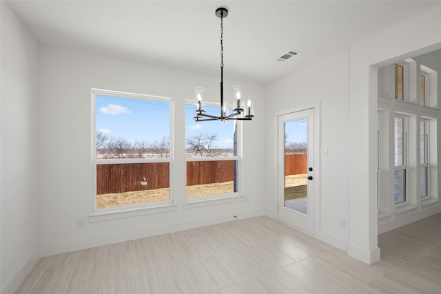 unfurnished dining area featuring an inviting chandelier