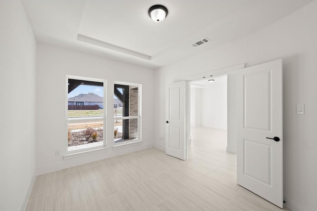 empty room with a raised ceiling