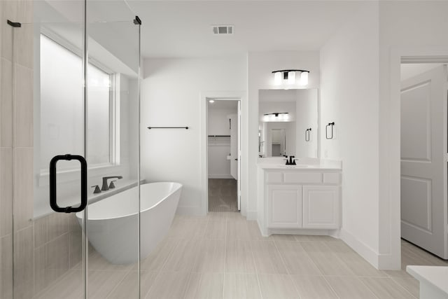 bathroom with vanity, shower with separate bathtub, and tile patterned floors