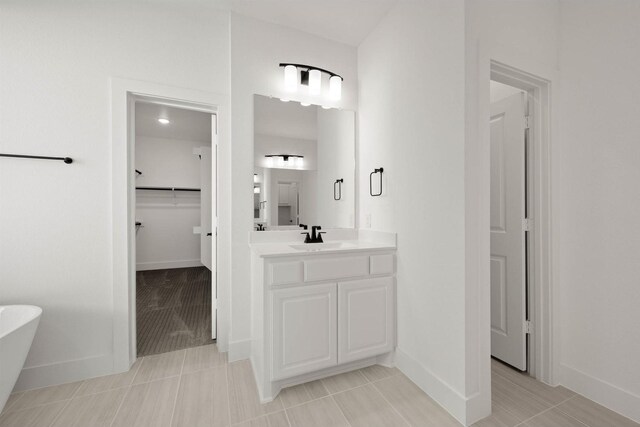 bathroom with vanity and a washtub