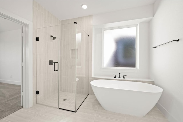 bathroom featuring separate shower and tub