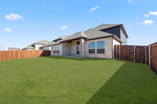 back of house with a lawn