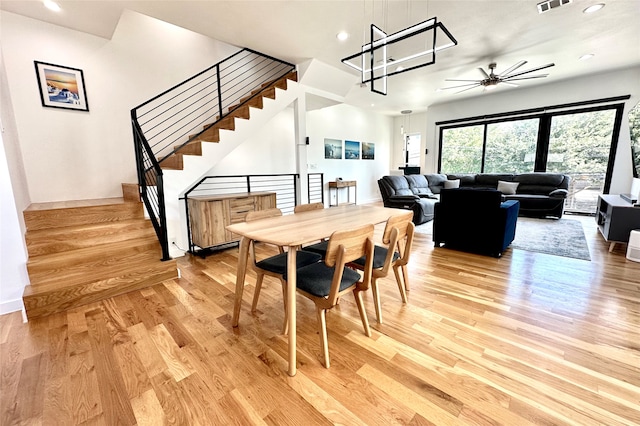 dining space featuring light wood-type flooring and ceiling fan