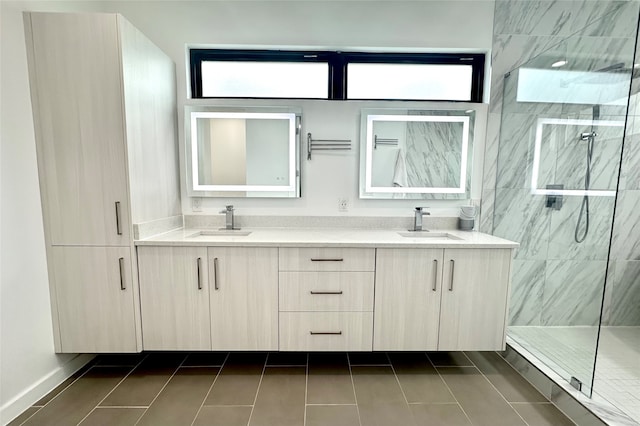 bathroom featuring tile patterned flooring, a shower with door, and vanity