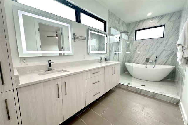 bathroom featuring tile walls, tile patterned floors, independent shower and bath, and vanity