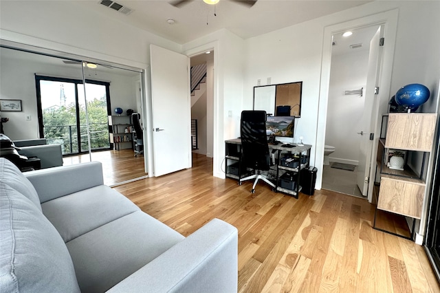 living room with ceiling fan and hardwood / wood-style flooring