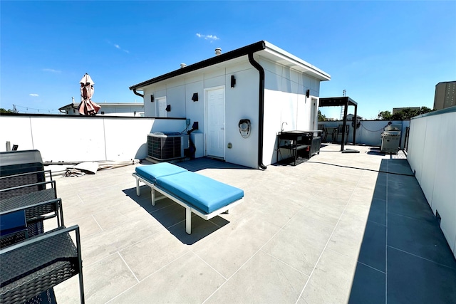 view of patio / terrace with an outdoor structure and central air condition unit