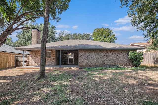 rear view of property featuring a patio area