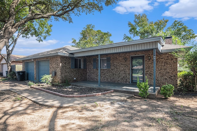 ranch-style home featuring a porch and a garage