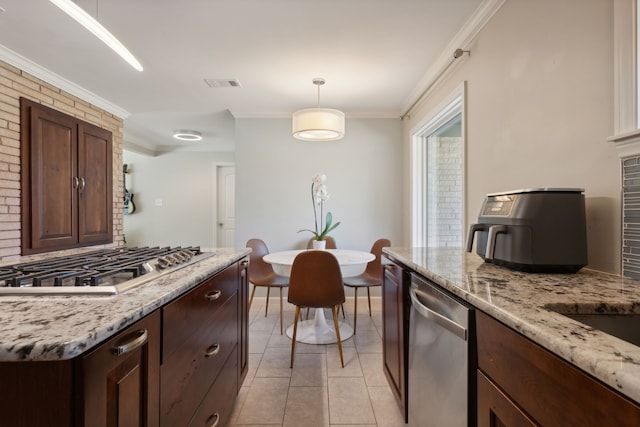 kitchen with light stone countertops, appliances with stainless steel finishes, crown molding, light tile patterned floors, and decorative light fixtures