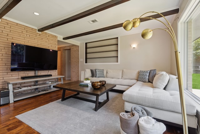 living room with beam ceiling, brick wall, dark hardwood / wood-style floors, and ornamental molding