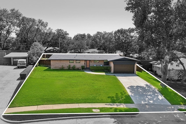 ranch-style home with a garage and a front yard