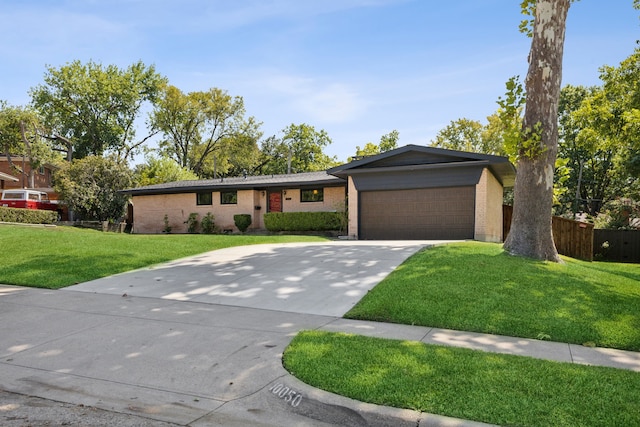 single story home with a garage and a front yard