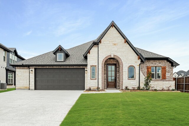 view of front facade with a garage and a front lawn