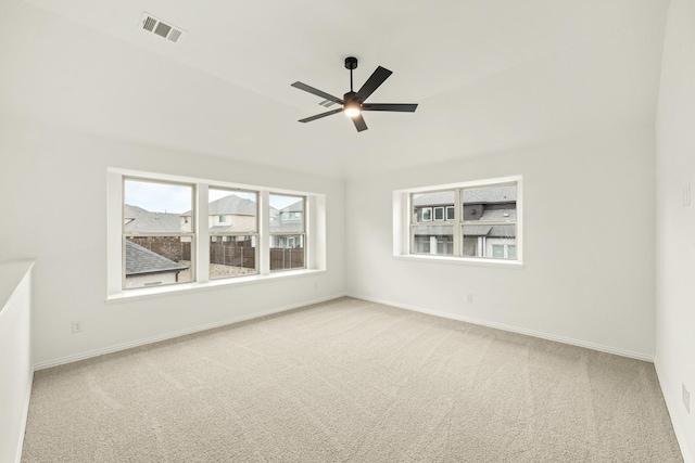 carpeted spare room with plenty of natural light and ceiling fan