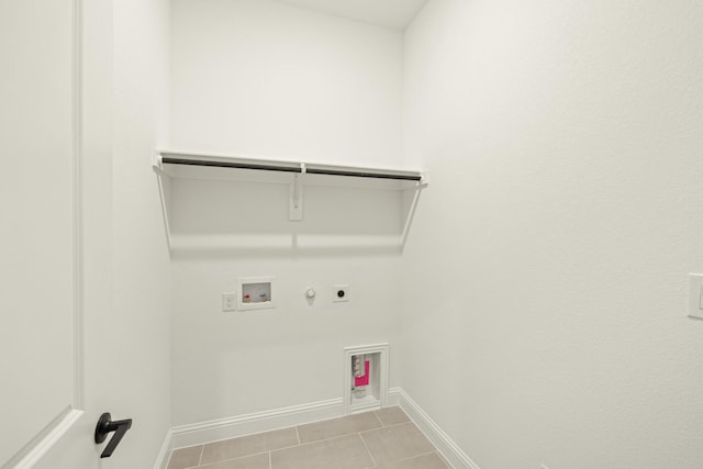 washroom featuring gas dryer hookup, hookup for an electric dryer, light tile patterned flooring, and hookup for a washing machine