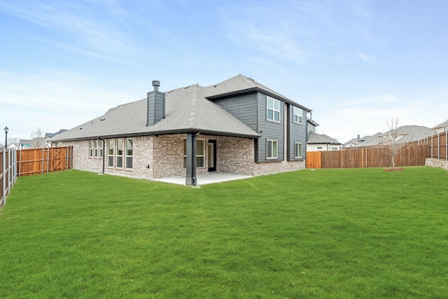 rear view of property featuring a patio area and a lawn