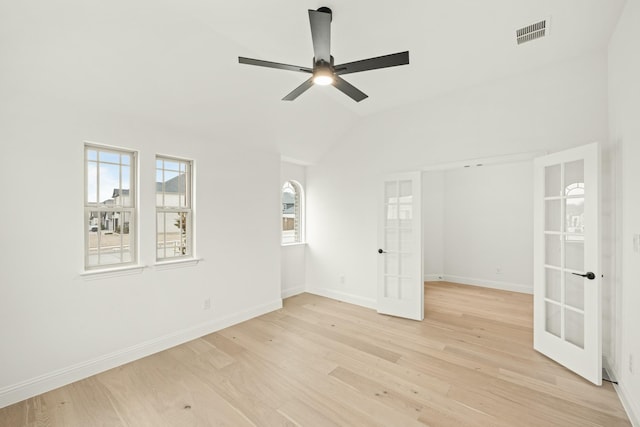 unfurnished room with french doors, ceiling fan, vaulted ceiling, and light hardwood / wood-style floors