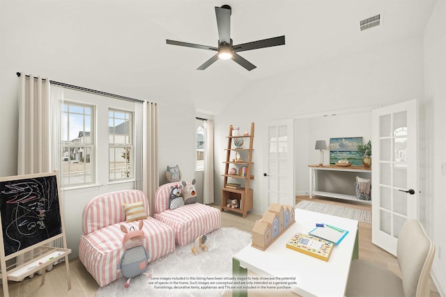 living room featuring french doors, lofted ceiling, ceiling fan, and light hardwood / wood-style flooring