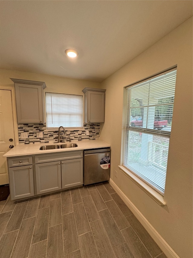 kitchen featuring backsplash, dishwasher, dark hardwood / wood-style floors, and sink