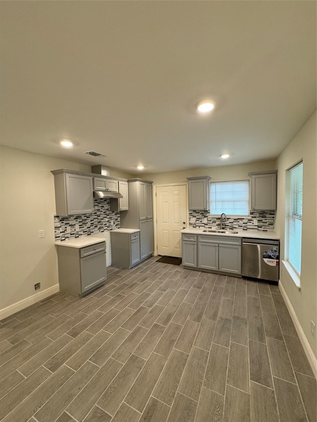 kitchen with dishwasher, dark hardwood / wood-style floors, and gray cabinetry