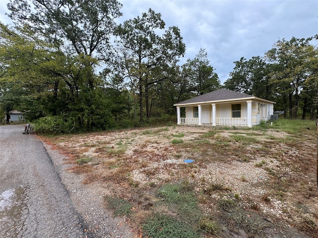 view of yard featuring a porch and central air condition unit