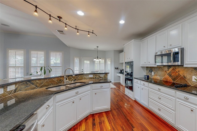 kitchen featuring dark wood-type flooring, sink, white cabinetry, black appliances, and ornamental molding