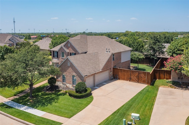 view of front of property featuring a garage and a front lawn