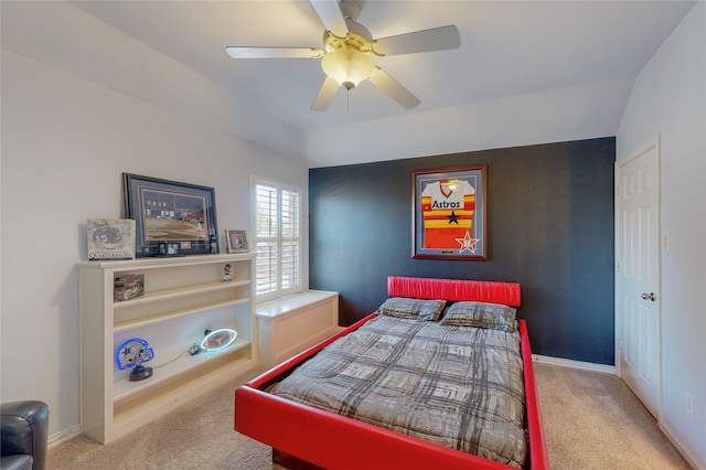 carpeted bedroom featuring lofted ceiling and ceiling fan